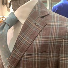 Load image into Gallery viewer, A tailored jacket with a notch lapel, featuring a brown and blue plaid pattern, displayed on a mannequin.