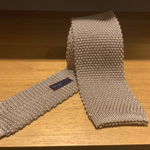 Load image into Gallery viewer, A knit tie with a textured pattern.
